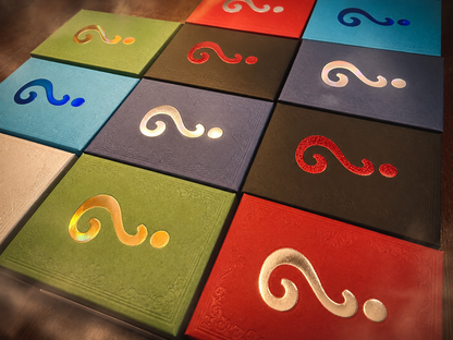 A grid of embossed square tiles in assorted colors, each featuring a raised decorative question mark symbol in a different color, photographed at an angle.