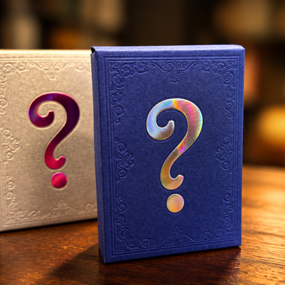 Three embossed mystery book boxes with large question marks on a wooden table, with a blurred library background. The boxes are blue, beige, and red.